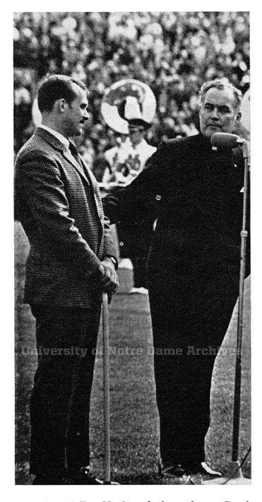 University President Rev. Theodore Hesburgh, C.S.C. introduces Bleier at halftime of the 1969 football game against USC. Bleier had just returned from the Vietnam War, where he had been injured.