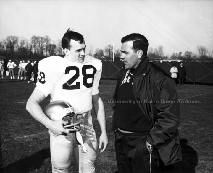 Head coach Ara Parseghian talks with captain Rocky Bleier on the sidelines at practice in 1967.