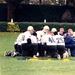 Head coach Lou Holtz and several Irish players take a knee at practice.